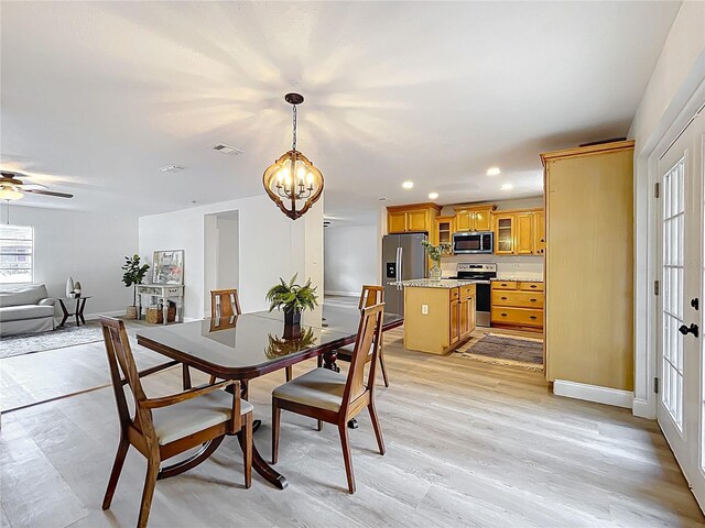 dining space with a chandelier, recessed lighting, a ceiling fan, baseboards, and light wood finished floors