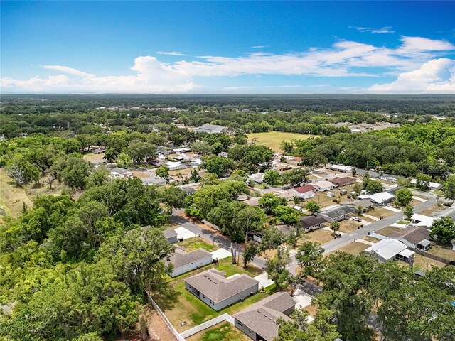 aerial perspective of suburban area with a heavily wooded area