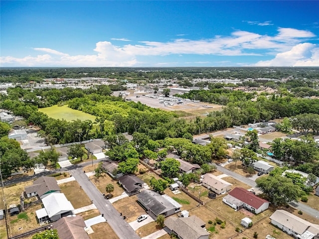 aerial view of residential area featuring a tree filled landscape