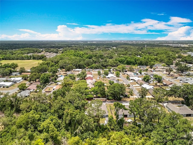 aerial view of residential area featuring a forest