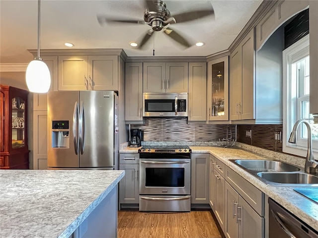 3804 Perugia Ave, Sebring, FL 33872 - kitchen featuring appliances with stainless steel finishes, gray cabinetry, a sink, light countertops, and recessed lighting