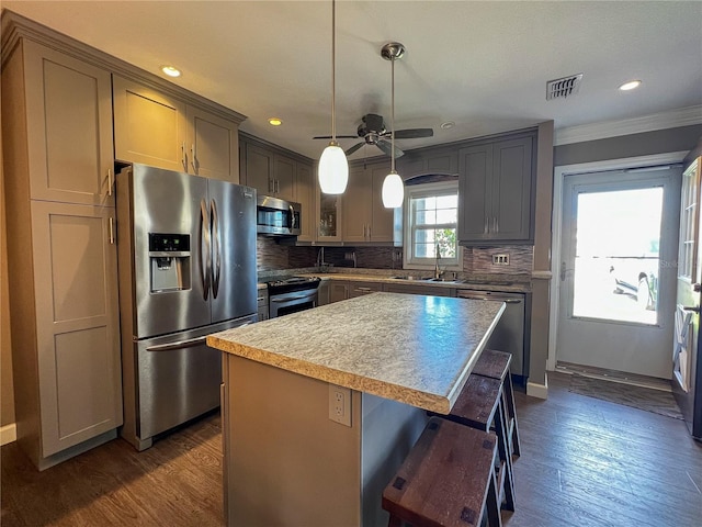 3804 Perugia Ave, Sebring, FL 33872 - kitchen with appliances with stainless steel finishes, crown molding, backsplash, dark wood-style floors, and recessed lighting