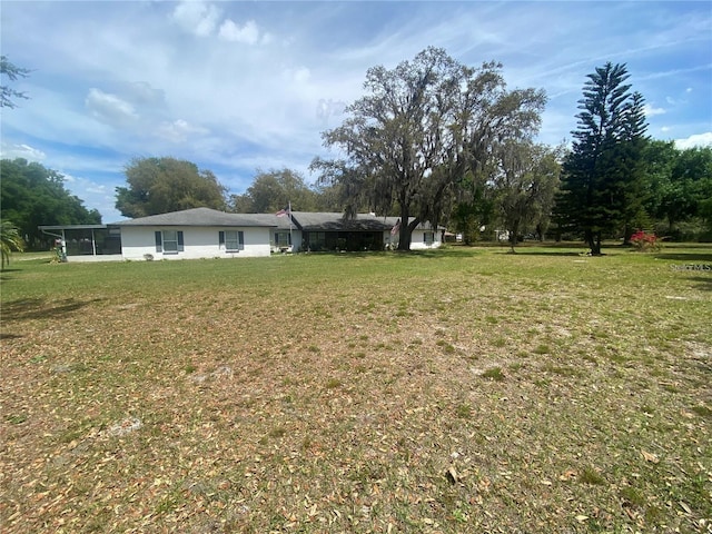 4151 Boggy Creek Rd, Kissimmee, FL 34744 - view of grassy yard featuring a sunroom