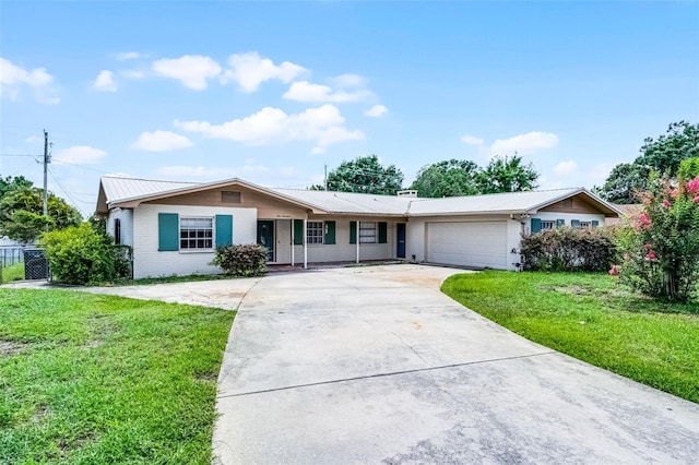 900 Howard Ter NW, Winter Haven, FL 33881 - ranch-style house featuring a front yard, an attached garage, driveway, and metal roof