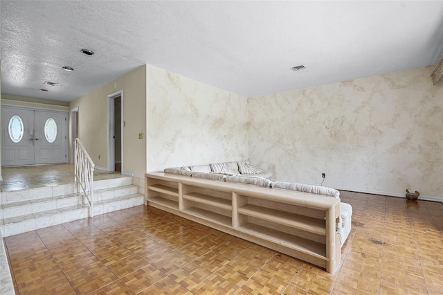 900 Howard Ter NW, Winter Haven, FL 33881 - empty room with a textured ceiling, wallpapered walls, and baseboards