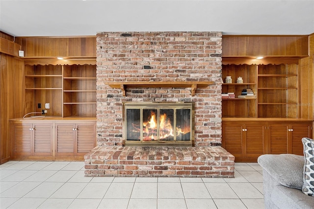 900 Howard Ter NW, Winter Haven, FL 33881 - unfurnished living room featuring tile patterned floors, wood walls, built in features, a fireplace, and wet bar