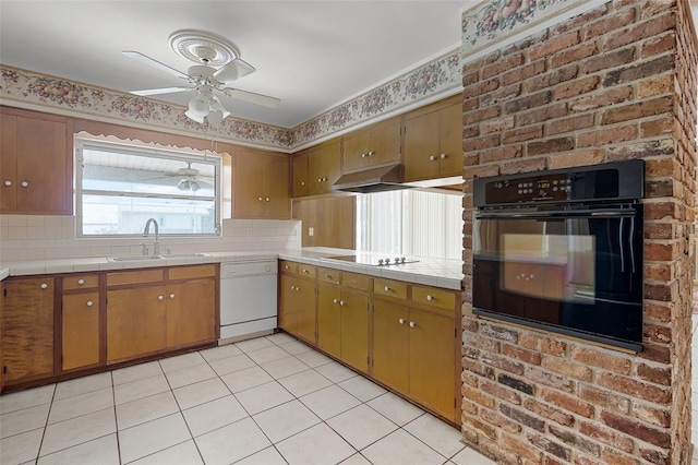 900 Howard Ter NW, Winter Haven, FL 33881 - kitchen featuring black appliances, a sink, ceiling fan, under cabinet range hood, and tile counters
