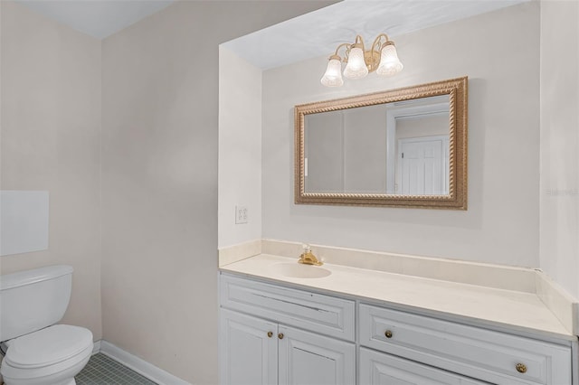900 Howard Ter NW, Winter Haven, FL 33881 - half bathroom featuring toilet, vanity, a chandelier, tile patterned flooring, and baseboards