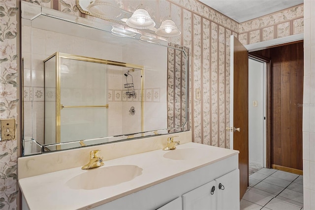 900 Howard Ter NW, Winter Haven, FL 33881 - bathroom featuring wallpapered walls, double vanity, tile patterned flooring, and tiled shower