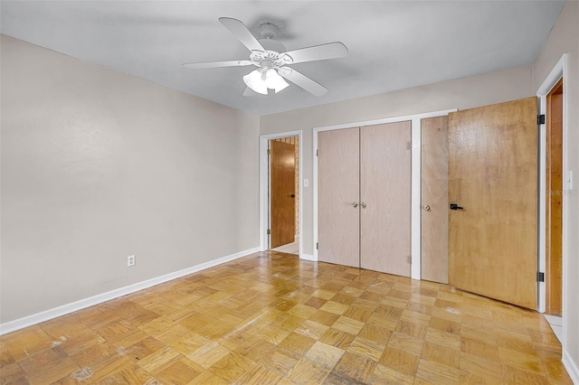 900 Howard Ter NW, Winter Haven, FL 33881 - unfurnished bedroom with multiple closets, baseboards, and ceiling fan