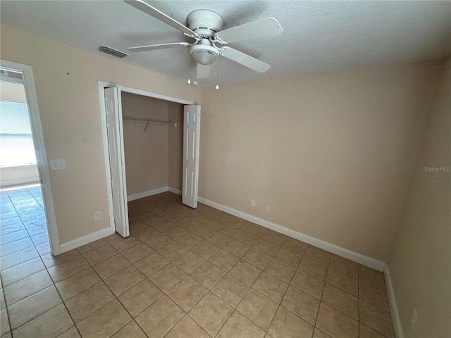 340 W Stanford St, Bartow, FL 33830 - unfurnished bedroom featuring light tile patterned floors, a closet, baseboards, and a ceiling fan