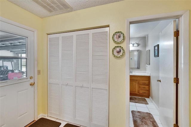 3154 Prairie Dunes Cir W, Lakeland, FL 33810 - doorway to outside with light tile patterned flooring and a sink
