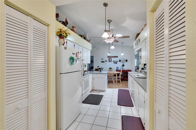 3154 Prairie Dunes Cir W, Lakeland, FL 33810 - kitchen with white appliances, a peninsula, a ceiling fan, light tile patterned floors, and light countertops