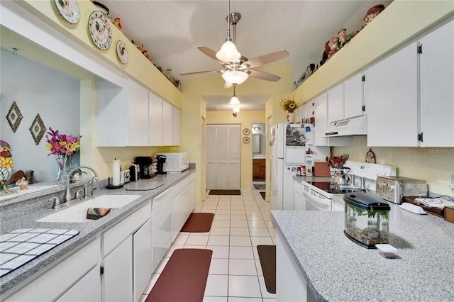 3154 Prairie Dunes Cir W, Lakeland, FL 33810 - kitchen with white appliances, under cabinet range hood, light tile patterned flooring, a ceiling fan, and white cabinets