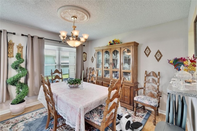 3154 Prairie Dunes Cir W, Lakeland, FL 33810 - dining room with a chandelier, light wood-type flooring, and a textured ceiling