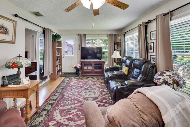 3154 Prairie Dunes Cir W, Lakeland, FL 33810 - living room featuring a textured ceiling, a ceiling fan, and wood finished floors