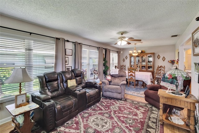 3154 Prairie Dunes Cir W, Lakeland, FL 33810 - living room with ceiling fan, a textured ceiling, and wood finished floors