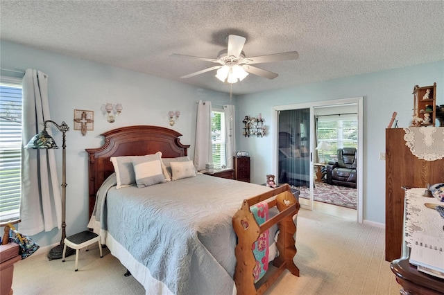 3154 Prairie Dunes Cir W, Lakeland, FL 33810 - bedroom with light colored carpet, multiple windows, a textured ceiling, and ceiling fan