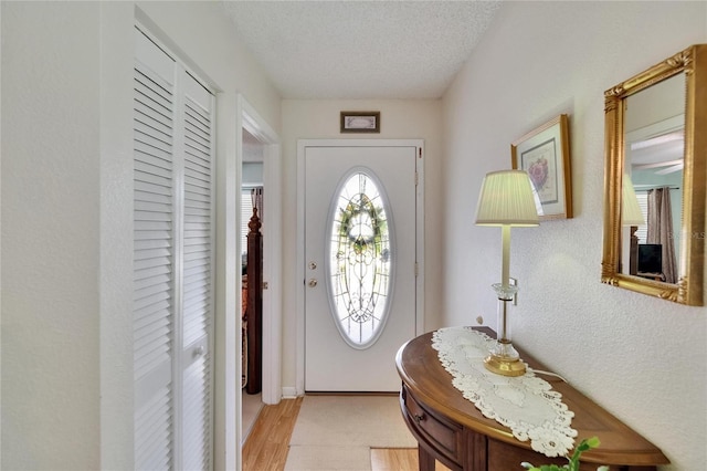 3154 Prairie Dunes Cir W, Lakeland, FL 33810 - foyer entrance with light wood-type flooring and a textured ceiling