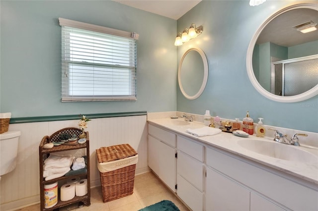 3154 Prairie Dunes Cir W, Lakeland, FL 33810 - full bath featuring double vanity, a stall shower, wainscoting, and tile patterned flooring