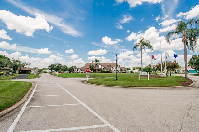 3154 Prairie Dunes Cir W, Lakeland, FL 33810 - view of asphalt street featuring traffic signs, curbs, and street lights
