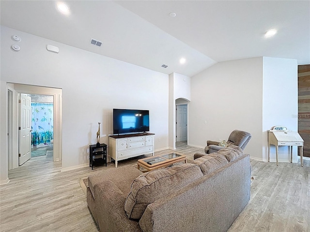 1205 Third Ct, Eagle Lake, FL 33839 - living area with arched walkways, vaulted ceiling, light wood-style floors, and recessed lighting