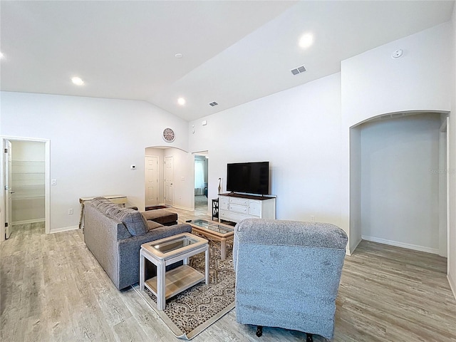 1205 Third Ct, Eagle Lake, FL 33839 - living room featuring light wood-type flooring, vaulted ceiling, recessed lighting, and arched walkways
