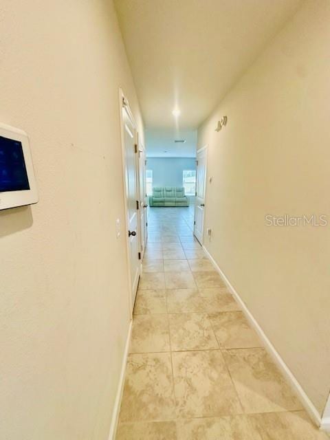 264 Fiddlewood Ct, Davenport, FL 33837 - corridor with light tile patterned floors and baseboards