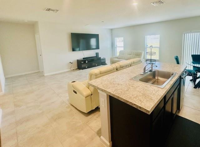 264 Fiddlewood Ct, Davenport, FL 33837 - kitchen with an island with sink, light countertops, light tile patterned floors, open floor plan, and dishwasher