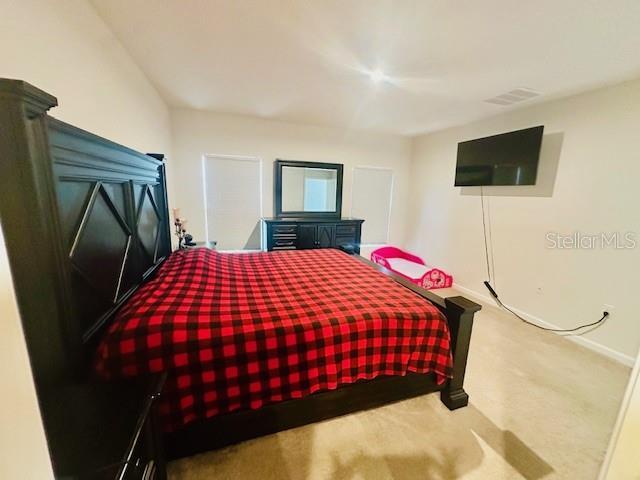 264 Fiddlewood Ct, Davenport, FL 33837 - carpeted bedroom with baseboards