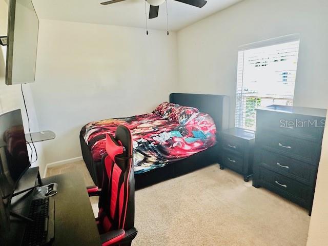 264 Fiddlewood Ct, Davenport, FL 33837 - bedroom with carpet and ceiling fan