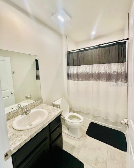 264 Fiddlewood Ct, Davenport, FL 33837 - full bathroom with vanity and shower / bath combo