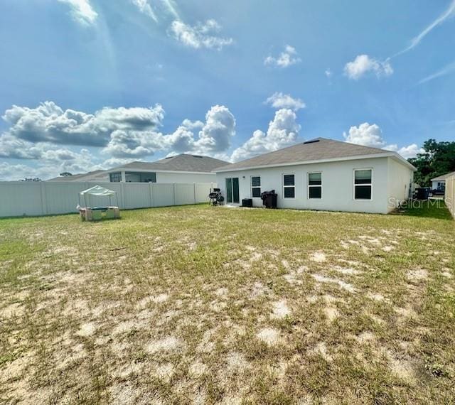 264 Fiddlewood Ct, Davenport, FL 33837 - back of house with stucco siding