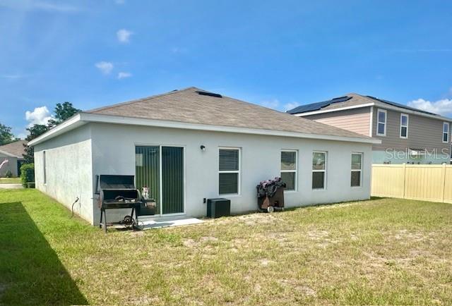 264 Fiddlewood Ct, Davenport, FL 33837 - rear view of property with stucco siding