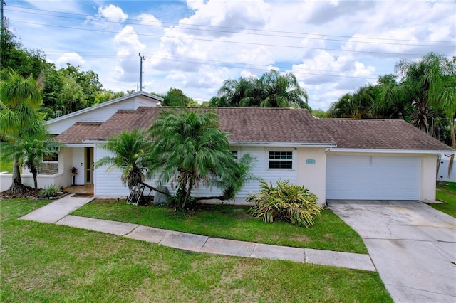 4966 Foxrun Ln, Lakeland, FL 33813 - single story home featuring concrete driveway, a front lawn, an attached garage, and stucco siding