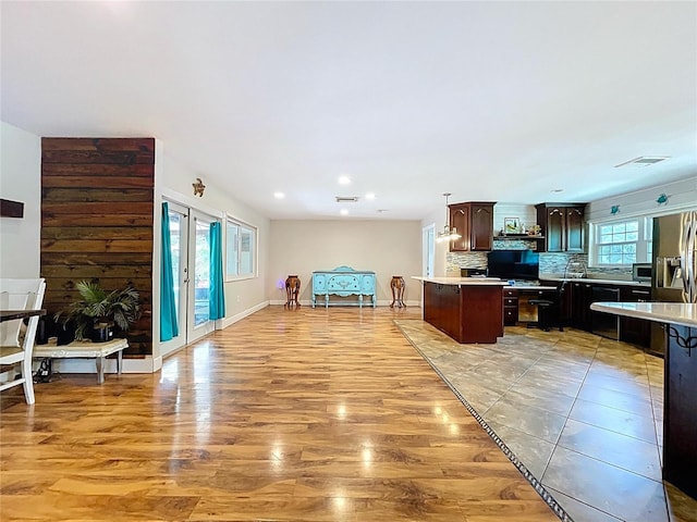 4966 Foxrun Ln, Lakeland, FL 33813 - kitchen featuring light wood-style floors, light countertops, decorative backsplash, recessed lighting, and dark brown cabinets