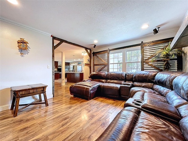 4966 Foxrun Ln, Lakeland, FL 33813 - living room with light wood-style floors, crown molding, a textured ceiling, and recessed lighting
