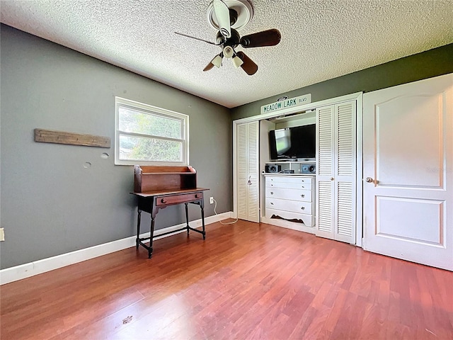 4966 Foxrun Ln, Lakeland, FL 33813 - sitting room with ceiling fan, dark wood-type flooring, and a textured ceiling