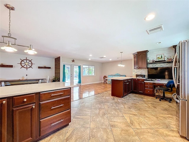4966 Foxrun Ln, Lakeland, FL 33813 - kitchen with freestanding refrigerator, french doors, a peninsula, light countertops, and recessed lighting