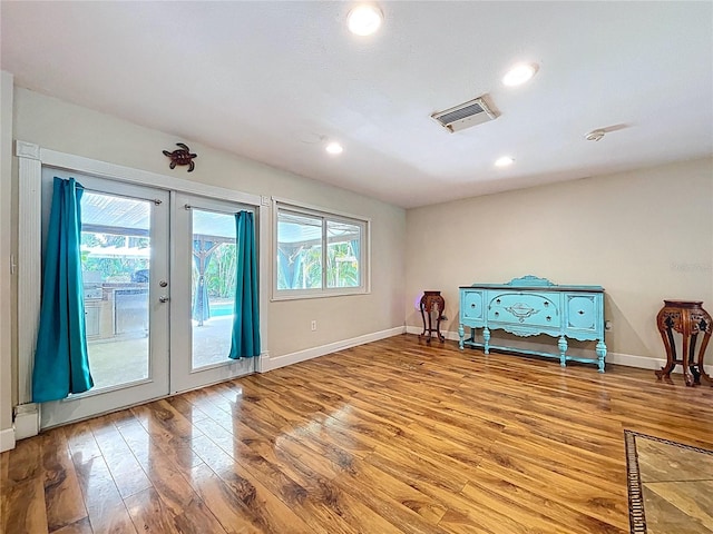 4966 Foxrun Ln, Lakeland, FL 33813 - spare room featuring french doors, wood finished floors, and recessed lighting