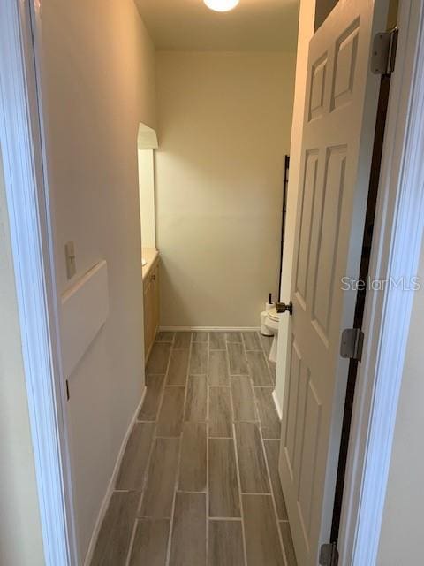 402 S Franklin St, Sebring, FL 33870 - laundry area with baseboards and wood finished floors