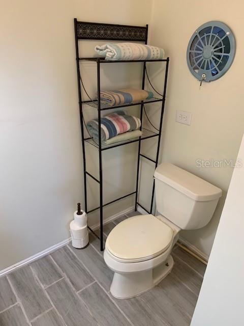 402 S Franklin St, Sebring, FL 33870 - bathroom with wood finished floors and toilet