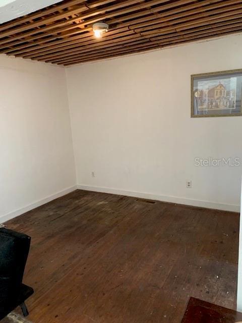 402 S Franklin St, Sebring, FL 33870 - below grade area with dark wood-type flooring and baseboards