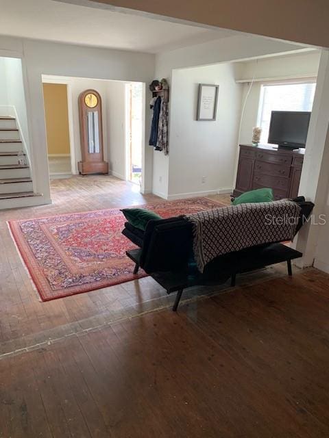 402 S Franklin St, Sebring, FL 33870 - living area with light wood finished floors and stairway