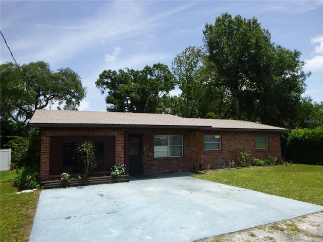 112 Bishop St, Auburndale, FL 33823 - single story home with brick siding and a front lawn