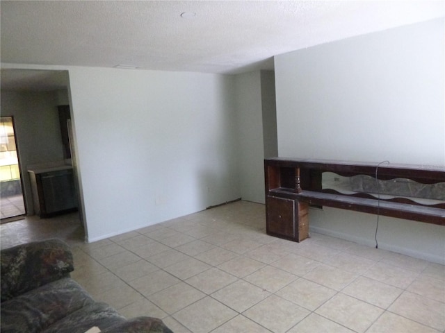 112 Bishop St, Auburndale, FL 33823 - unfurnished living room with a textured ceiling and light tile patterned flooring