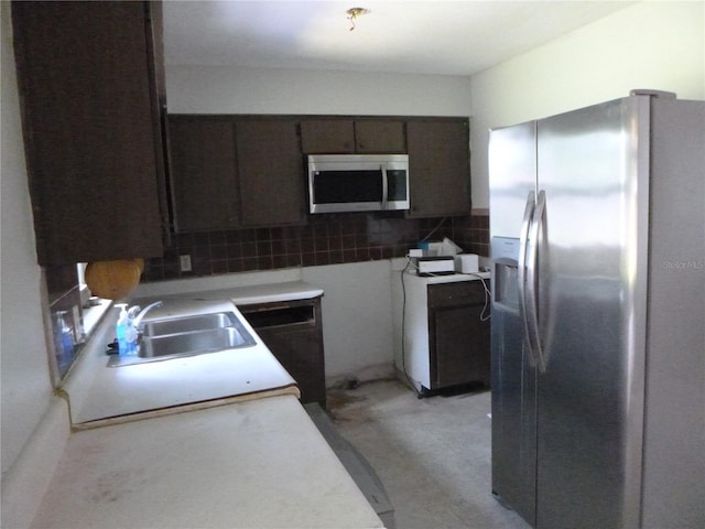 112 Bishop St, Auburndale, FL 33823 - kitchen featuring appliances with stainless steel finishes, decorative backsplash, light countertops, and dark brown cabinets