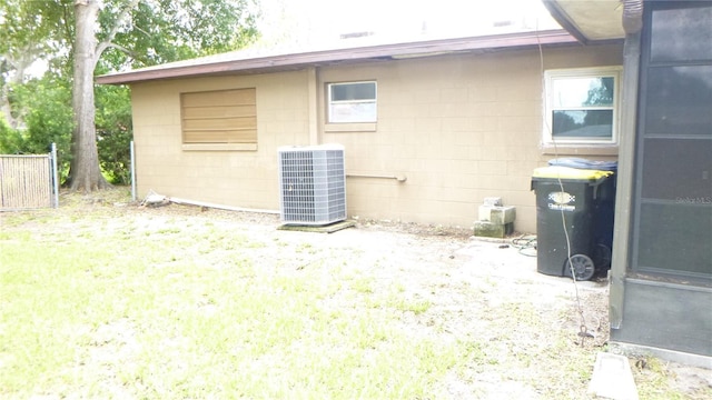 112 Bishop St, Auburndale, FL 33823 - view of property exterior with a cooling unit and concrete block siding