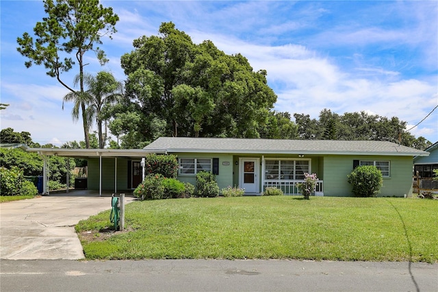 733 Oleander Dr SE, Winter Haven, FL 33880 - single story home with a front lawn, driveway, and an attached carport
