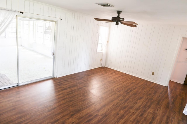 733 Oleander Dr SE, Winter Haven, FL 33880 - spare room with a ceiling fan, wood finished floors, healthy amount of natural light, and wood walls